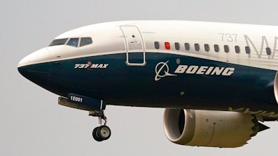 In this Sept. 30, 202, file photo, a Boeing 737 Max jet, piloted by Federal Aviation Administration (FAA) chief Steve Dickson, prepares to land at Boeing Field following a test flight in Seattle.