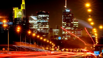 Long time exposure photo shows commuters driving towards Frankfurt, Germany, Thursday, Jan. 14, 2021. In background the buildings of the banking district.