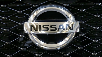 This Feb. 14, 2013 file photo shows the Nissan logo on the grill of a 2013 Nissan Pathfinder on display at the 2013 Pittsburgh Auto Show in Pittsburgh. Nissan is recalling over 354,000 Pathfinder SUVs worldwide because the brake lights can stay on all the time. It's the second recall for the same problem. The recall covers certain Pathfinders from the 2013 through 2015 model years.