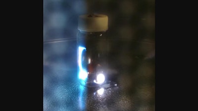 Sparks generated inside a glass vial containing coal powder and copper foil in a microwave oven.
