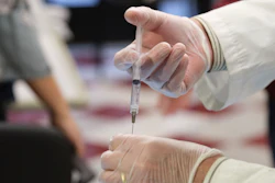 CVS Pharmacist Gerard Diebner prepares a shot of the COVID-19 vaccine for the nursing home residents at Harlem Center for Nursing and Rehabilitation.