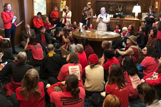 Demonstrators against a proposed liquid-natural gas pipeline and export terminal sit in in the governor's office, Salem, Ore., Nov. 21, 2019.