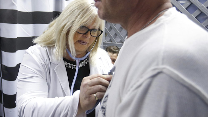 Dr. Tricia Derges listens to a patient's chest at the Lift Up Springfield medical clinic in Springfield, Mo., Dec. 14, 2018.