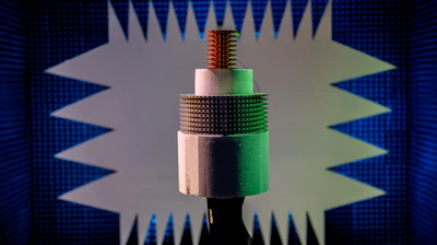 Two arrays await testing in the compact range at the U.S. Naval Research Laboratory, Washington, D.C., Sep. 5, 2019. The two white parts are Styrofoam supports—between the Styrofoam is an array built using traditional machining methods (all metal cylindrical array). On top is a 3D printed sector array. A similar setup with be tested before the end of 2020 to compare the performance of traditionally manufactured parts against 3D printed parts.