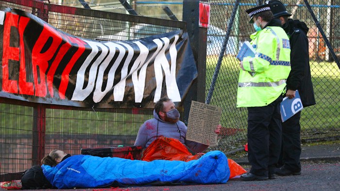 Police talk to protesters blocking the entrance to the Elbit Ferranti arms company, Oldham, England, Feb. 1, 2021.