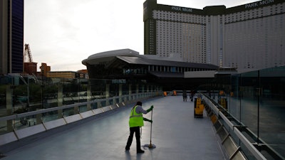 A worker cleans along the Las Vegas Strip, March 31, 2020.