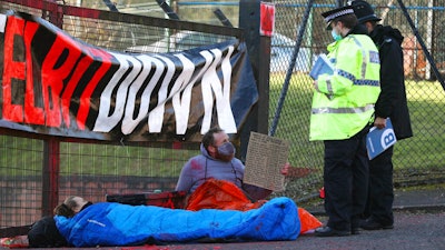 Police talk to protesters blocking the entrance to the Elbit Ferranti arms company, Oldham, England, Feb. 1, 2021.