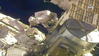 Astronauts Mike Hopkins, left, and Victor Glover work outside the International Space Station, Feb. 1, 2021.