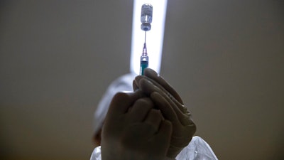 A medical worker prepares a shot of Russia's Sputnik V coronavirus vaccine in Moscow, Dec. 30, 2020.