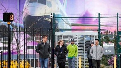 Workers exit a gate at Boeing's airplane manufacturing plant in Renton, Wash., March 23, 2020.