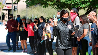 Naelyn Pike leads a prayer outside the federal courthouse in Phoenix, Feb. 2, 2021.