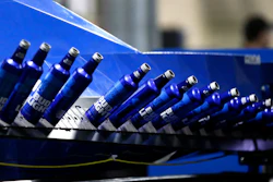 In this April 8, 2016, file photo, aluminum Bud Light bottles move along a conveyor at a plant manufacturing 16-ounce Budweiser and Bud Light aluminum bottles for Anheuser-Busch, in Arnold, MO.