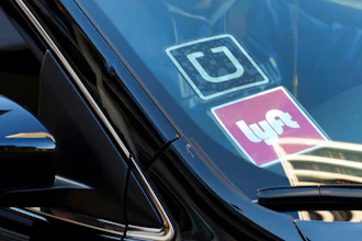 Ride-share car displaying Lyft and Uber stickers, Los Angeles, Jan. 12, 2016.