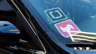 Ride-share car displaying Lyft and Uber stickers, Los Angeles, Jan. 12, 2016.