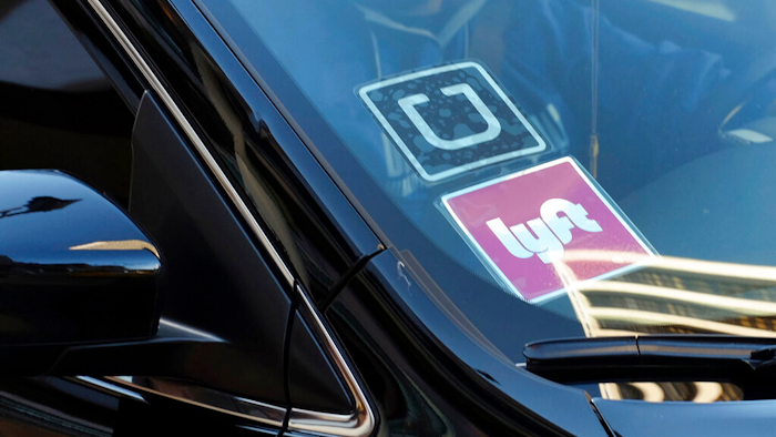 Ride-share car displaying Lyft and Uber stickers, Los Angeles, Jan. 12, 2016.