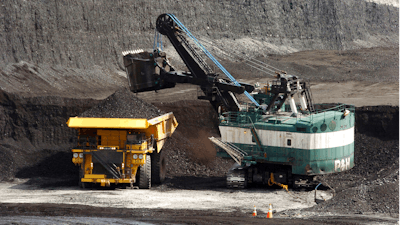A mechanized shovel loads a haul truck with coal at the Spring Creek coal mine near Decker, Mont., April 4, 2013.