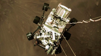 The Perseverance rover lowered towards the surface of Mars during its powered descent, Feb. 18, 2021.