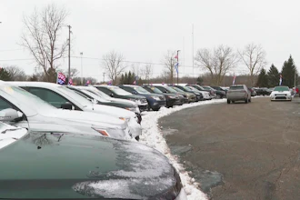 Cars drive through the used vehicle lot at a LaFontaine auto dealership in Fenton Township, Mich., Jan. 28, 2021.