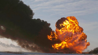 A fireball goes up at the site of an oil train derailment near Casselton, N.D., Dec. 30, 2013.
