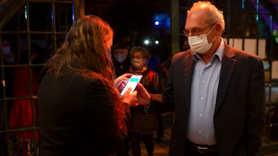 A man presents his 'green passport,' proof that he is vaccinated against the coronavirus, at the Khan Theater in Jerusalem, Feb. 23, 2021.