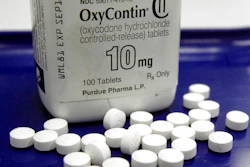 This Feb. 19, 2013, file photo shows OxyContin pills arranged for a photo at a pharmacy in Montpelier, Vt. The global business consulting firm McKinsey & Company has agreed to a $573 million settlement over its role in the opioid crisis, according to a person with knowledge of the deal. An announcement is expected Thursday, Feb. 4, 2021.