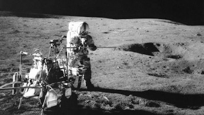 Apollo 14 astronaut Alan Shepard conducts an experiment near a lunar crater, Feb. 6, 1971.