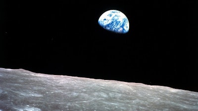 The Earth behind the surface of the moon during the Apollo 8 mission, Dec. 24, 1968.