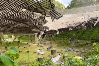 A 100-foot gash, created by a broken cable and metal platform, in the radio telescope's reflector dish in Arecibo, Puerto Rico, Aug. 11, 2020.