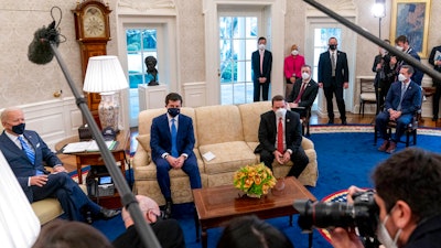 From left, President Joe Biden, Transportation Secretary Pete Buttigieg, House Transportation and Infrastructure Committee Ranking Member Rep. Sam Graves, R-Mo., Rep. Brian Fitzpatrick, R-Pa., Highways and Transit Subcommittee Ranking Member Rep. Rodney Davis, R-Ill., and other members of the House of Representatives meet in the Oval Office, March 4, 2021.