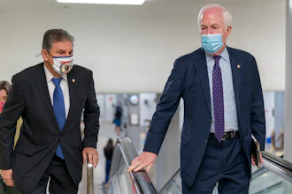 Sens. Joe Manchin, D-W.Va., left, and John Cornyn, R-Texas, head to the Senate chamber, March 5, 2021.