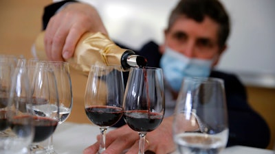 Philippe Darriet, president of the Institute for Wine and Vine Research, fills glasses at the ISVV Institute in Villenave-d'Ornon, France, March 1, 2021.