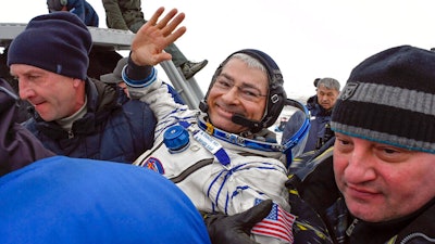 Ground personnel carry NASA astronaut Mark Vande Hei after landing in Kazakhstan, Feb. 28, 2018.
