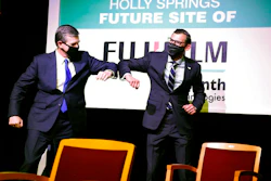 N.C. Gov. Roy Cooper, left, elbow-bumps with Martin Meeson, CEO of Fujifilm Diosynth Biotechnologies, Holly Springs, N.C., March 18, 2021.