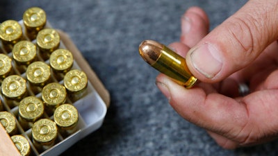 Chris Puehse, owner of Foothill Ammo, displays .45-caliber ammunition for sale at his store in Shingle Springs, Calif., June 11, 2019.