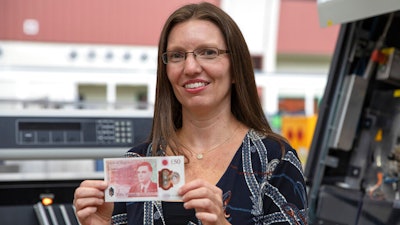 Sarah John, chief cashier at the Bank of England, holds the new 50-pound note featuring scientist Alan Turing, March 25, 2021.