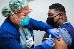 A nurse administers a dose of the Pfizer COVID-19 vaccine at Texas Southern University in Houston, Feb. 11, 2021.
