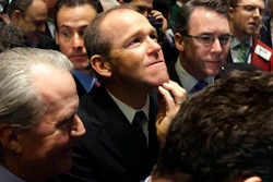 In this Jan. 26, 2011 file photo, Nielsen Company CEO David Calhoun, center, watches progress as he waits for the company's IPO to begin trading, on the floor of the New York Stock Exchange. Boeing CEO David Calhoun declined a salary and performance bonus for most of 2020 but still received stock benefits that pushed the estimated value of his compensation to more than $21 million, according to a regulatory filing Friday, March 5, 2021.
