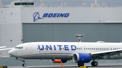 In this Nov. 18, 2020, file photo a Boeing 737 Max 9 built for United Airlines lands at King County International Airport - Boeing Field after a test flight from Moses Lake, Wash., in Seattle. United Airlines is expanding its order of Boeing 737 Max airplanes and taking some deliveries sooner as it ramps up for an anticipated increase in travel demand. Chief Operating Officer Andrew Nocella said in a memo on Monday, March 1, 2021, that the company placed an order for 25 new 737 Max aircraft for delivery in 2023.