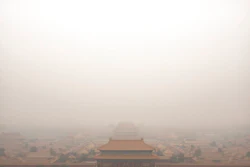 In this Jan. 18, 2020, file photo, a bird flies over the Forbidden City on a day with high levels of air pollution in Beijing. China's Premier Li Keqiang announced that the country would target a reduction of 18% in carbon intensity over the course of the next five years as part of the meeting of the ceremonial legislature which kicked off its annual meeting Friday, March 5, 2021.