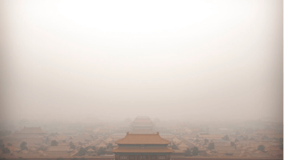 In this Jan. 18, 2020, file photo, a bird flies over the Forbidden City on a day with high levels of air pollution in Beijing. China's Premier Li Keqiang announced that the country would target a reduction of 18% in carbon intensity over the course of the next five years as part of the meeting of the ceremonial legislature which kicked off its annual meeting Friday, March 5, 2021.