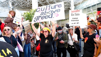 Protesters rally outside the Rio Tinto office in Perth, Australia, on June 9, 2020. Rio Tinto chairman Simon Thompson said Wednesday, March 3, 2021 he was accountable for the mining giant destroying sacred Indigenous sites in Australia to access iron ore and he will not seek reelection as a board director next year.