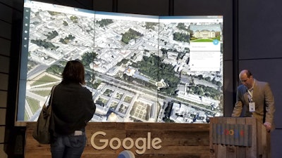 Sean Askay, right, engineering manager with Google Earth, demonstrates its features in New York, April 18, 2017.