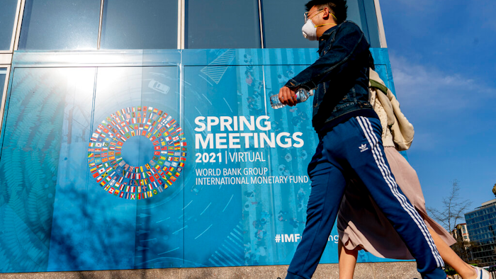 A poster displayed on the International Monetary Fund building, April 5, 2021, Washington.