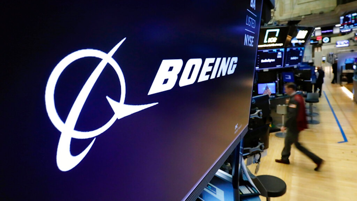 In this March 11, 2019 file photo, the Boeing logo appears above a trading post on the floor of the New York Stock Exchange before the opening bell. Boeing is suing a subcontractor it hired to work on new Air Force One planes that will carry the president of the United States. Boeing says a subcontractor on in Fort Worth, Texas, missed deadlines for work on the planes.