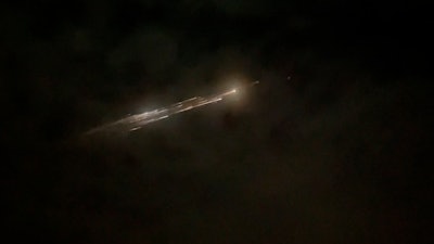 Image taken from video showing debris from a SpaceX rocket behind clouds over Vancouver, Wash., March 25, 2021.