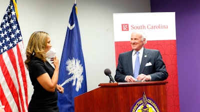Benedict College President Roslyn Clark Artis and South Carolina Gov. Henry McMaster at a news conference in Columbia, March 30, 2021.