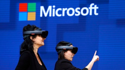 Members of a design team at Cirque du Soleil demonstrate Microsoft's HoloLens at the company's developers conference in Seattle, May 11, 2017.