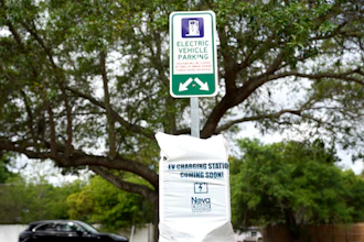 A parking area with charging stations for electric vehicles at a public park in Orlando, Fla., April 1, 2021.