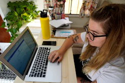 Kelly Mack works on her laptop to teach remotely from her home in Evanston, Ill., Sept. 2, 2020.