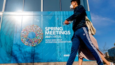A poster displayed on the International Monetary Fund building, April 5, 2021, Washington.